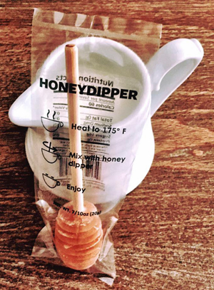 Keez Beez products include a honey dipper or swizzle stick for dissolving honey in hot beverages.